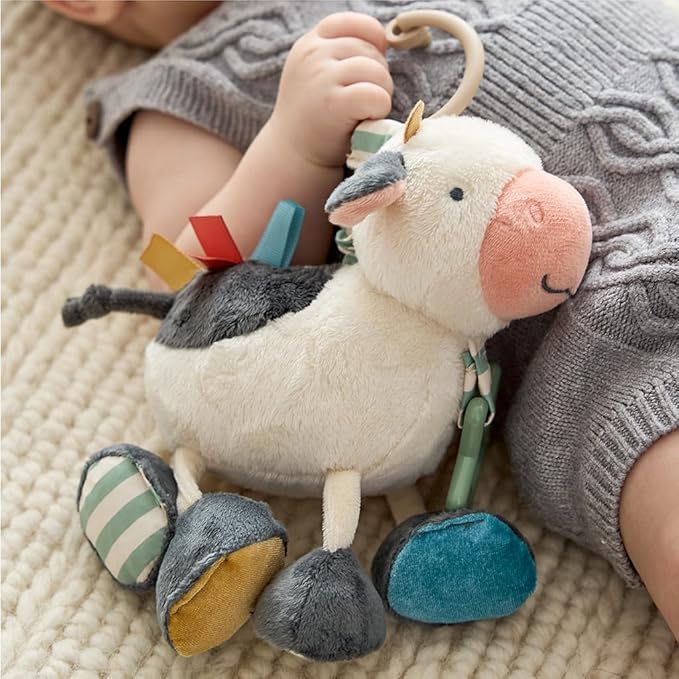 Itzy Ritzy Link & Love Toy for Stroller or Car Seat; Features Textured Ribbons, Crinkle Sounds, Clinking Rings & Silicone Teether; Designed for Ages 0 Months and Up (Cow)