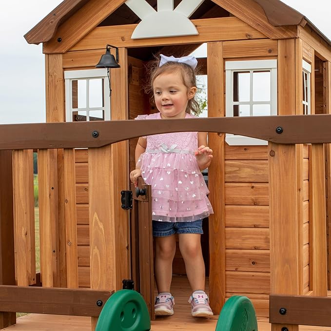 Backyard Discovery Echo Heights Elevated Cedar Wooden Kids Playhouse with Wave Slide, Play Kitchen, Wrap-Around Deck, Flat-Step Ladder, Half Door, Windows, Bell, and Growth Chart for Outdoor Play