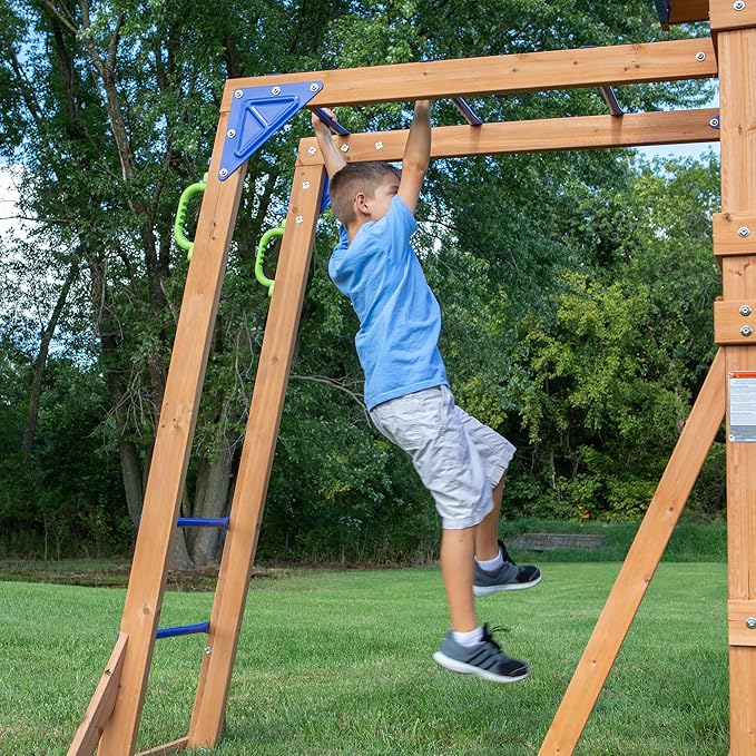 Backyard Discovery Beach Front Cedar Wood Swing Set with Wave Slide, Play Deck, Monkey Bars, Rock Wall Ladder, Shaded Picnic Area, Snack Bar, Belt Swings, Trapeze, Sandbox Area, Outdoor Playset