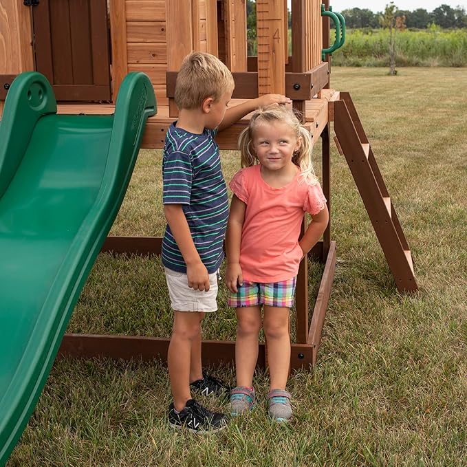 Backyard Discovery Echo Heights Elevated Cedar Wooden Kids Playhouse with Wave Slide, Play Kitchen, Wrap-Around Deck, Flat-Step Ladder, Half Door, Windows, Bell, and Growth Chart for Outdoor Play