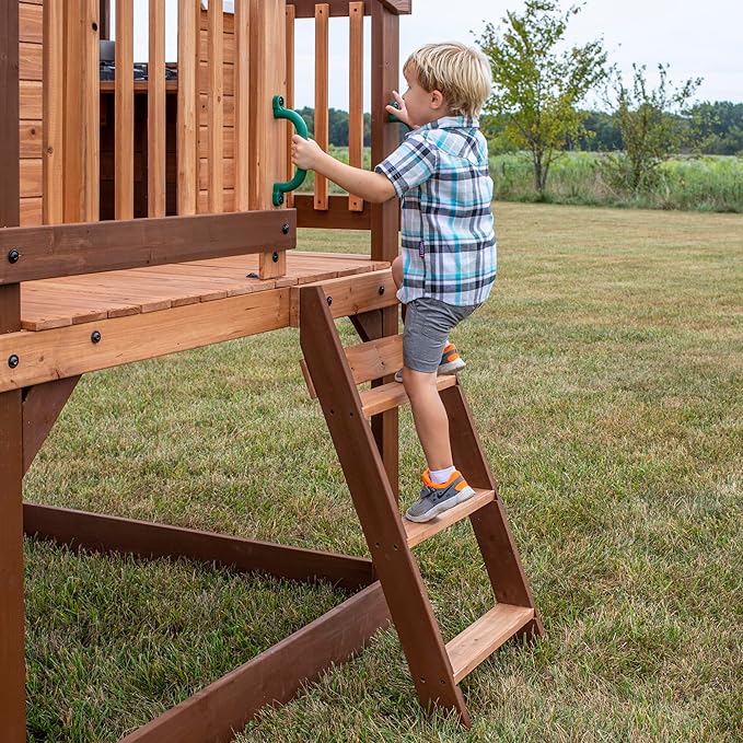 Backyard Discovery Echo Heights Elevated Cedar Wooden Kids Playhouse with Wave Slide, Play Kitchen, Wrap-Around Deck, Flat-Step Ladder, Half Door, Windows, Bell, and Growth Chart for Outdoor Play